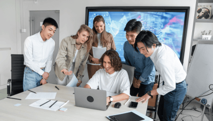 Employees looking at laptop